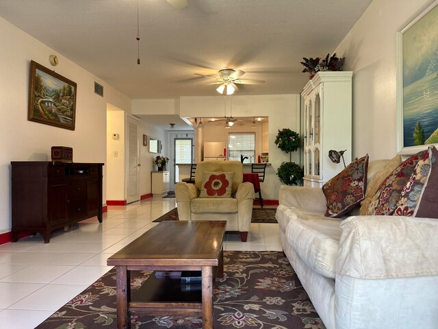 living room featuring ceiling fan and light tile floors