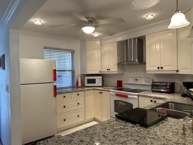 kitchen featuring white cabinetry, wall chimney range hood, white appliances, and sink