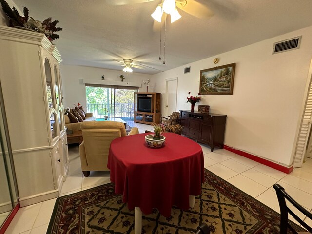 tiled dining area featuring ceiling fan