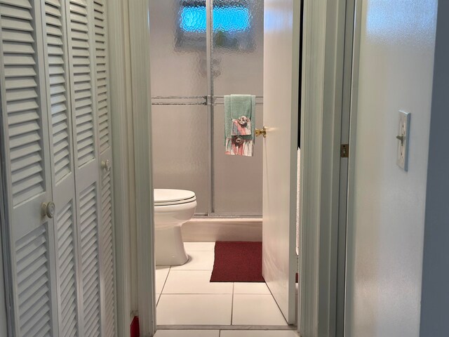 bathroom with tile flooring and toilet