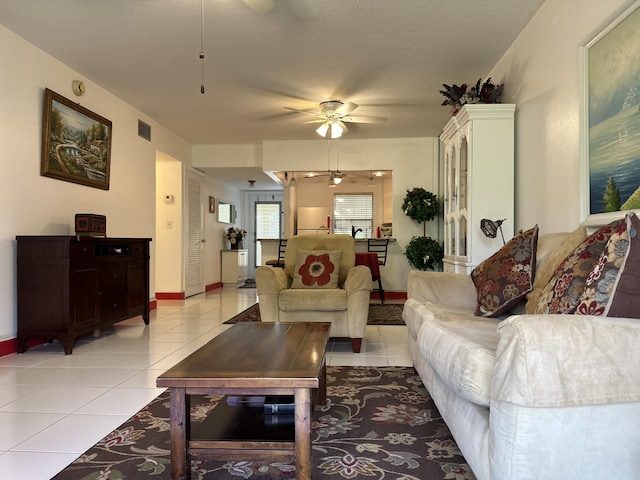 living room with light tile patterned floors and ceiling fan