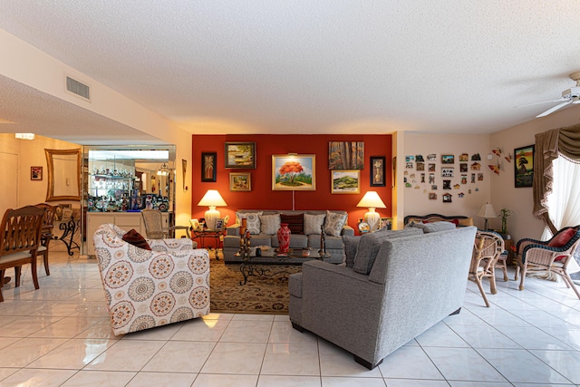 living room with light tile patterned floors, a textured ceiling, and ceiling fan