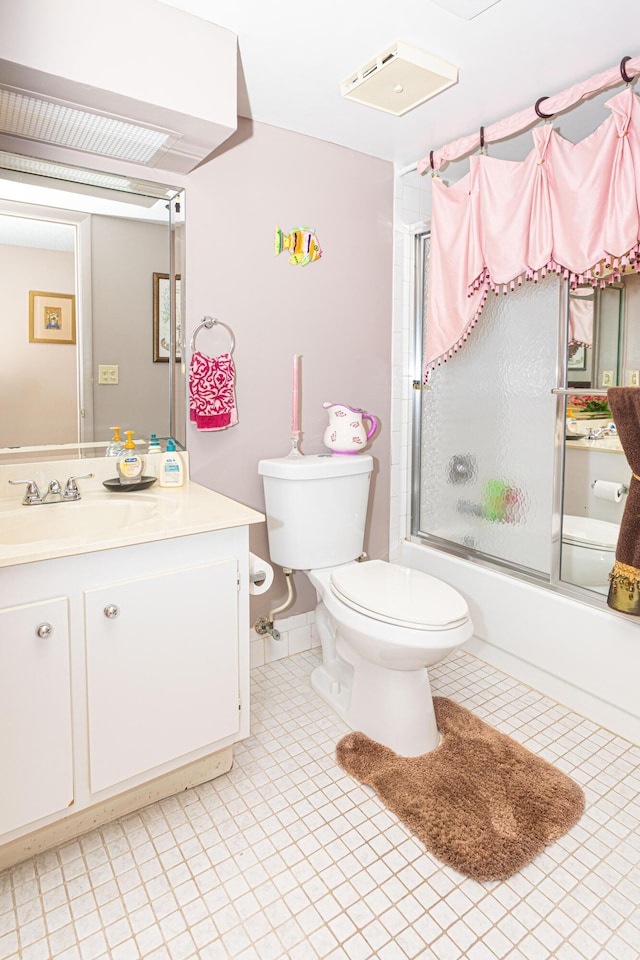 full bathroom featuring toilet, vanity, and shower / bath combination with glass door