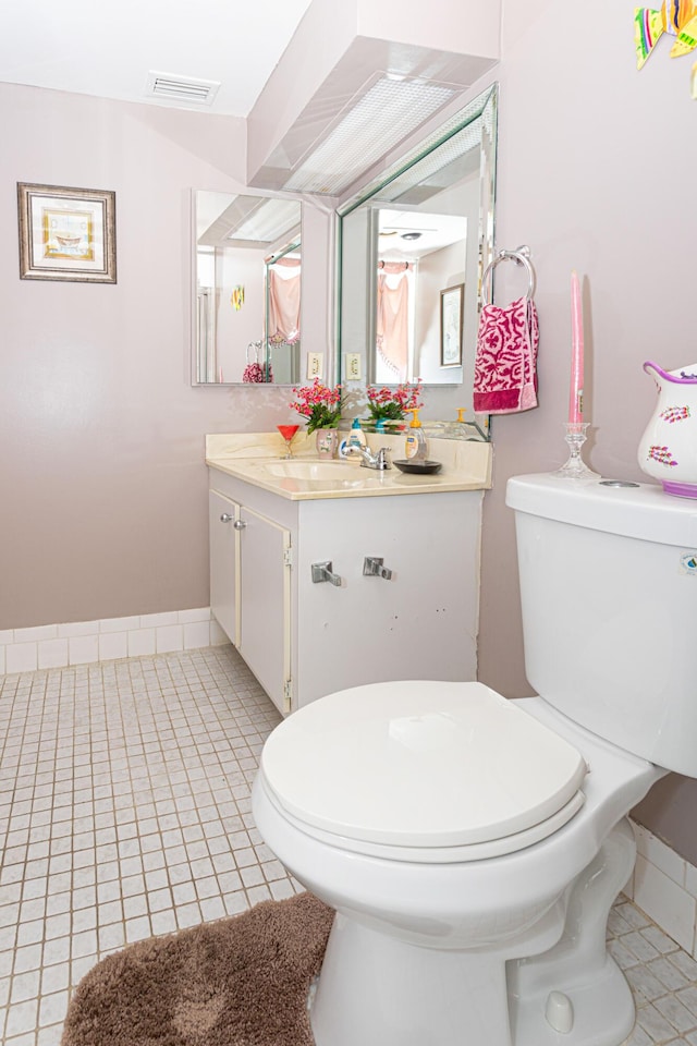 bathroom with vanity, tile patterned floors, and toilet