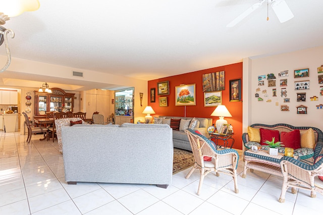 living room featuring light tile patterned floors and ceiling fan