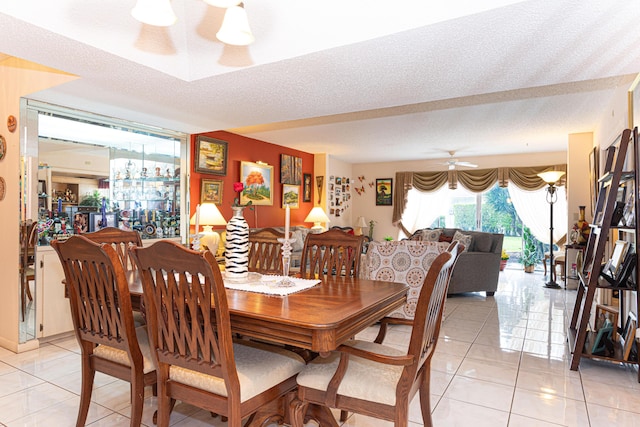 dining room with light tile patterned floors, a textured ceiling, and ceiling fan