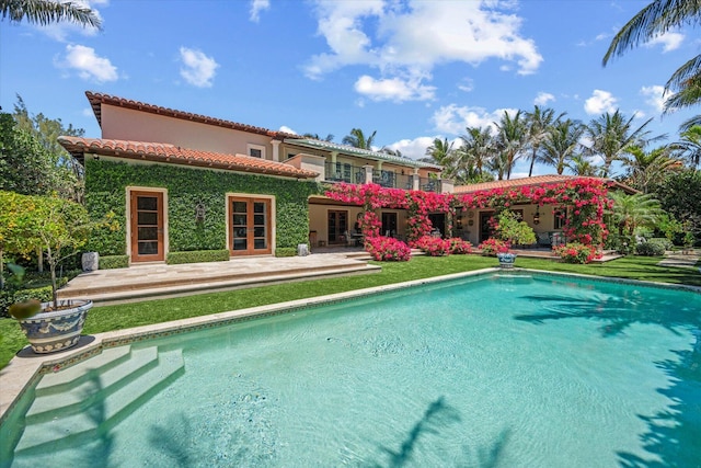 rear view of property with french doors and a patio