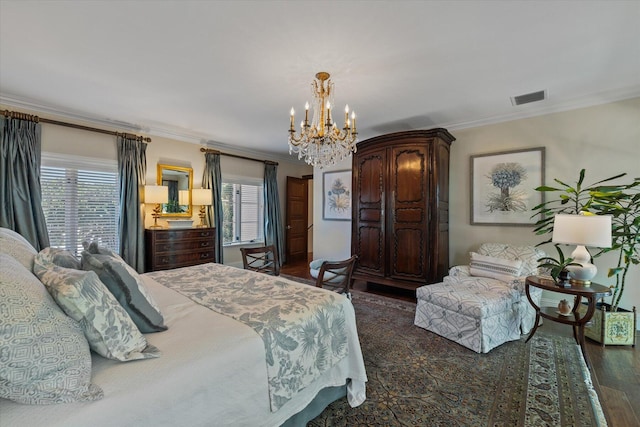 bedroom with dark hardwood / wood-style flooring, crown molding, and a notable chandelier