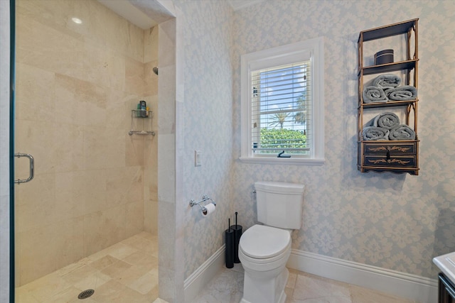 bathroom with a tile shower and toilet