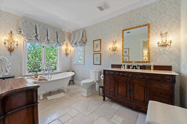 bathroom featuring crown molding, a washtub, vanity, and toilet