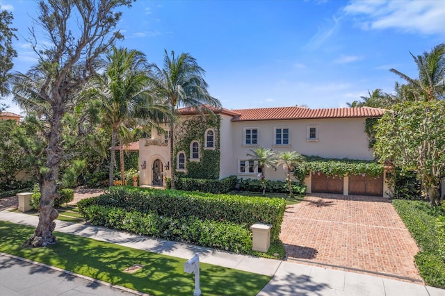 mediterranean / spanish home with a garage