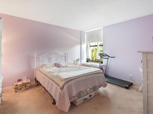 bedroom with light colored carpet and a textured ceiling