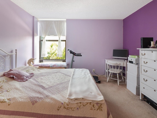 bedroom featuring light colored carpet and a textured ceiling