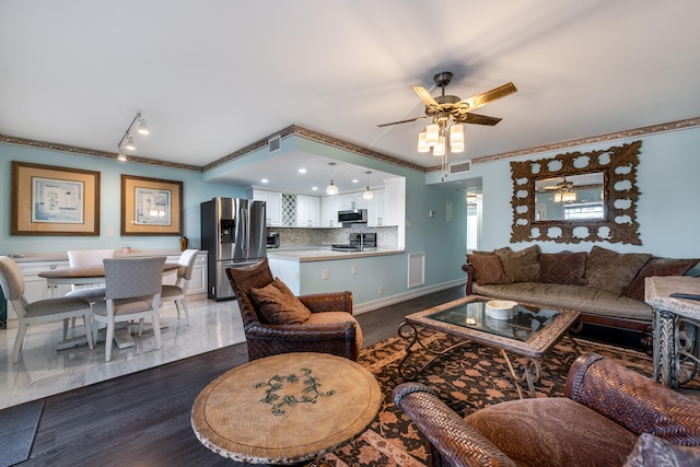 living room with wood-type flooring, ceiling fan, and crown molding