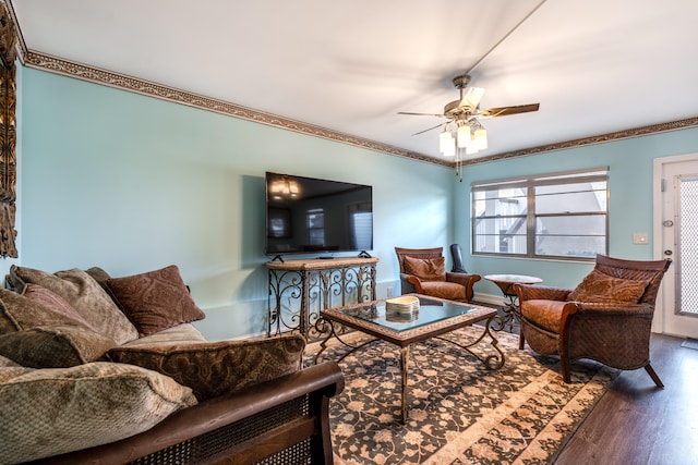 living room featuring wood-type flooring, ceiling fan, and ornamental molding