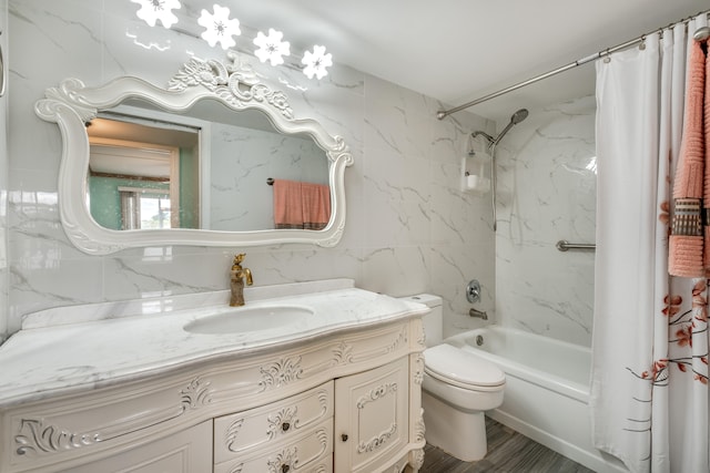 full bathroom with vanity, toilet, tile walls, and shower / tub combo with curtain