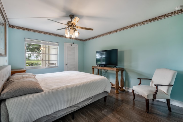 bedroom with ornamental molding, dark wood-type flooring, and ceiling fan