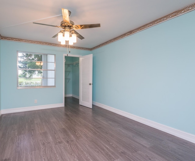 spare room featuring dark hardwood / wood-style flooring, ceiling fan, and crown molding