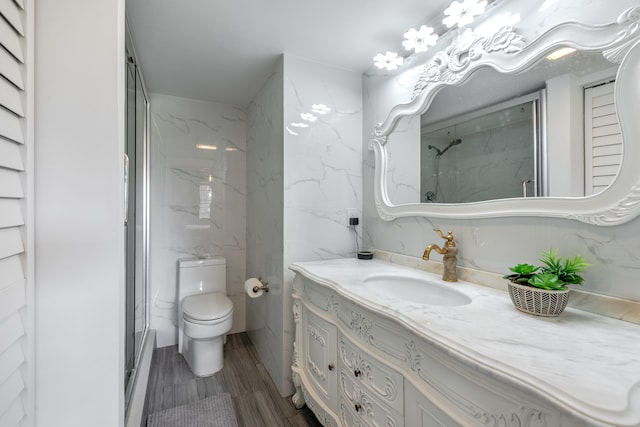 bathroom featuring tile walls, vanity, and toilet