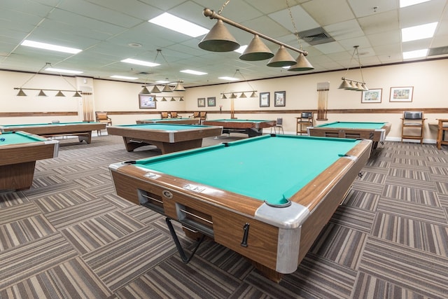 recreation room with dark colored carpet, a paneled ceiling, and billiards