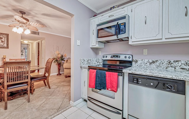 kitchen with light stone countertops, appliances with stainless steel finishes, ceiling fan, crown molding, and light tile floors