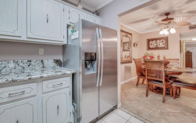 kitchen featuring crown molding, ceiling fan, light tile floors, and stainless steel refrigerator with ice dispenser