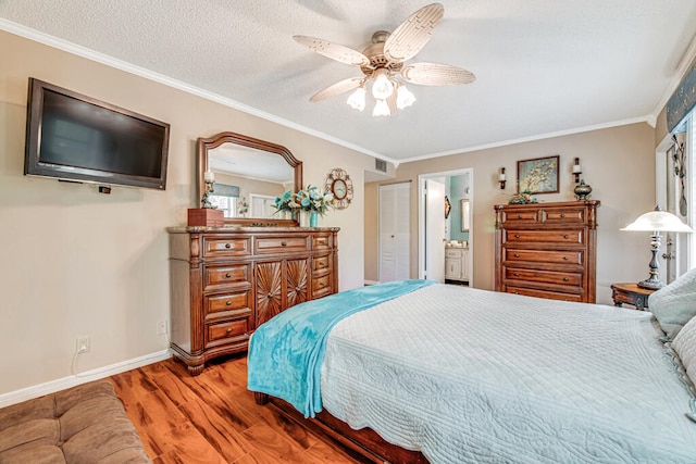 bedroom with wood-type flooring, ceiling fan, ensuite bathroom, and ornamental molding