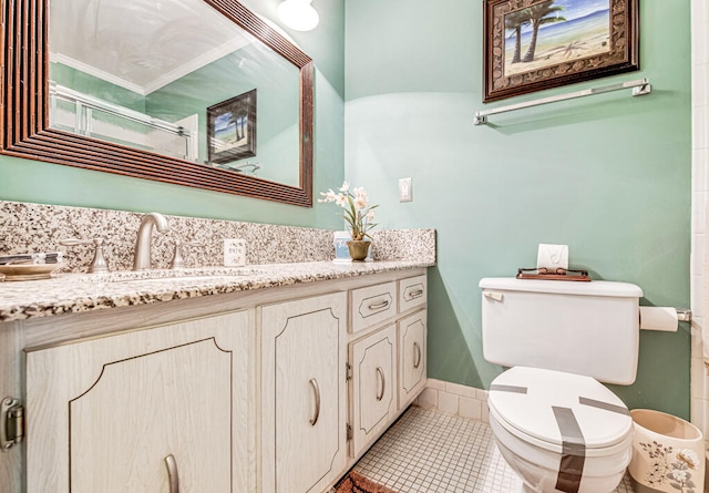 bathroom with toilet, tile floors, and large vanity