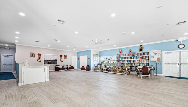 interior space with light hardwood / wood-style flooring, crown molding, and ceiling fan