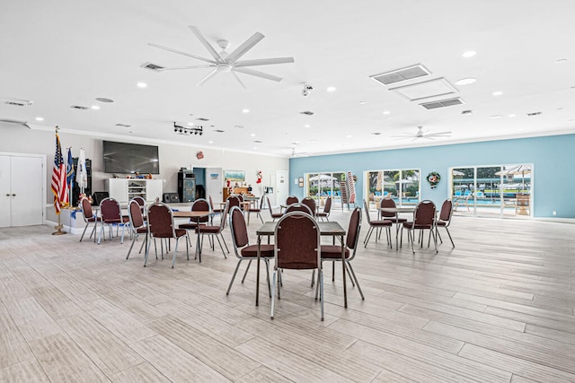 dining area with light hardwood / wood-style floors and ceiling fan