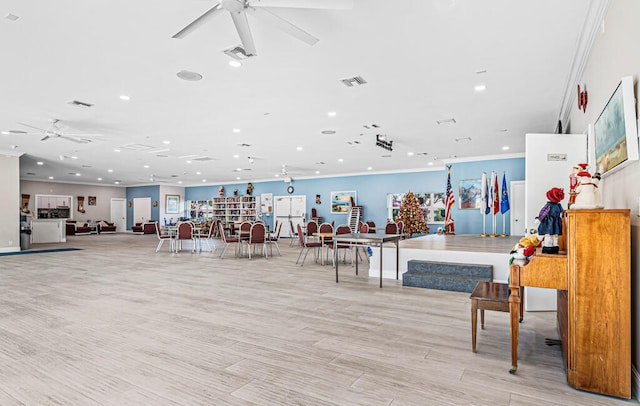 interior space featuring ornamental molding, ceiling fan, and light wood-type flooring