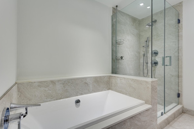 bathroom featuring shower with separate bathtub