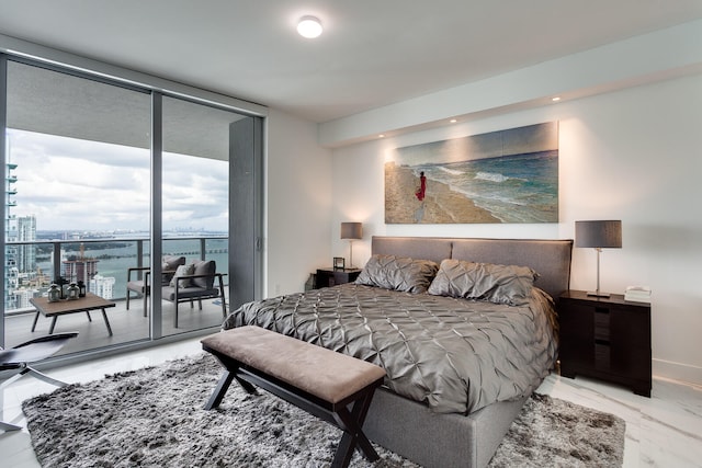 bedroom featuring expansive windows and access to exterior