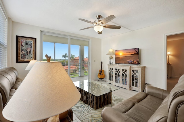 living room featuring a textured ceiling and ceiling fan