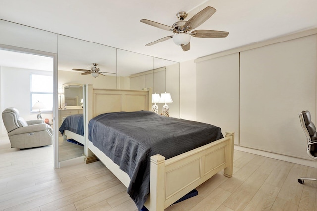 bedroom with ceiling fan and light hardwood / wood-style flooring