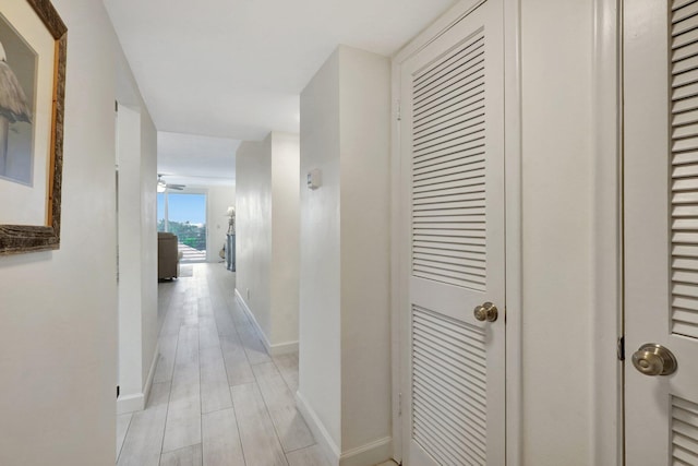 corridor with light hardwood / wood-style floors