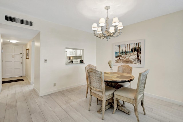 dining room featuring a notable chandelier and light hardwood / wood-style floors