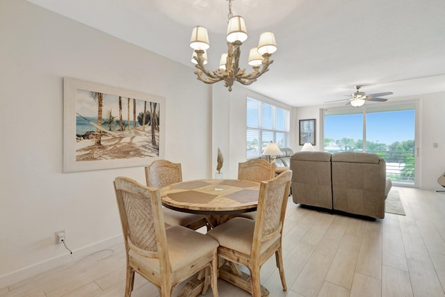 dining area featuring light hardwood / wood-style floors and ceiling fan with notable chandelier