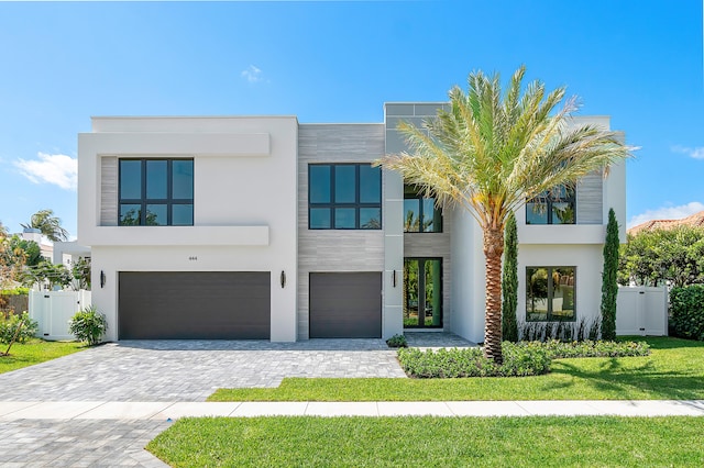 modern home featuring a garage and a front yard