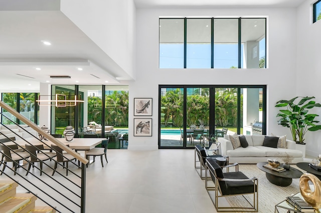 tiled living room featuring a healthy amount of sunlight and a high ceiling