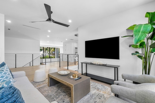 living room featuring ceiling fan and light wood-type flooring