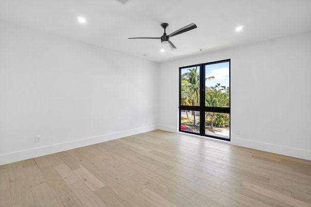 unfurnished room with ceiling fan and light wood-type flooring