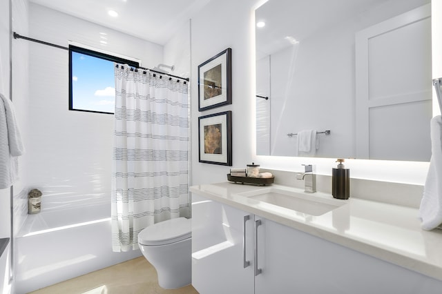 full bathroom featuring vanity with extensive cabinet space, shower / bath combo, and toilet