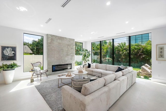 living room with tile floors and a fireplace