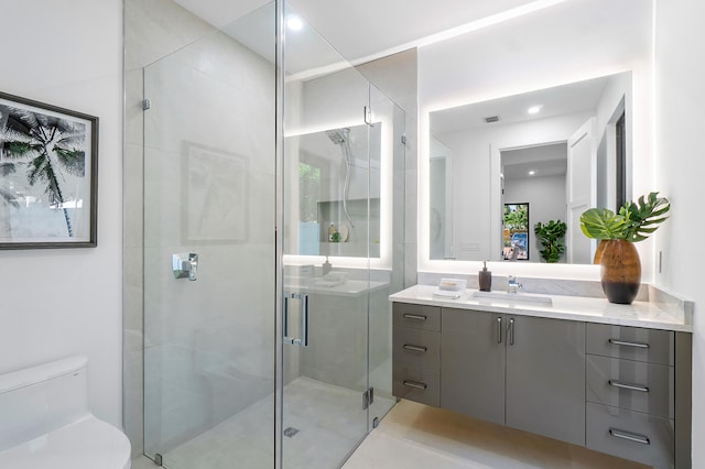 bathroom with walk in shower, toilet, and oversized vanity