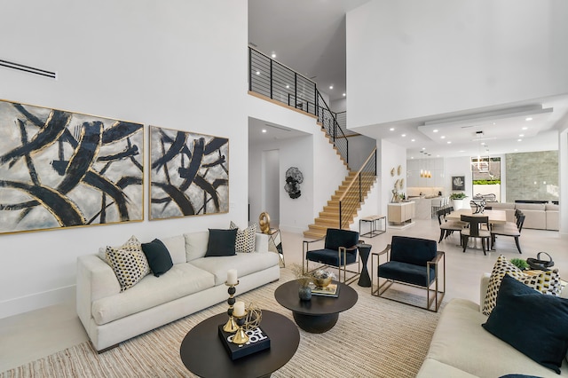 living room featuring a notable chandelier and a high ceiling