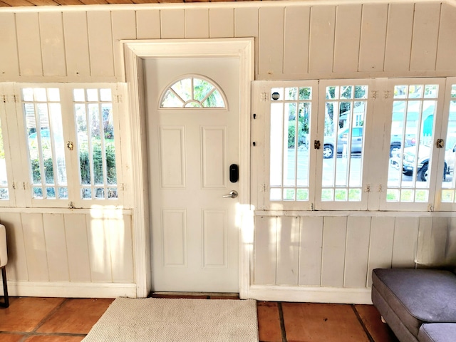 foyer entrance with wooden walls