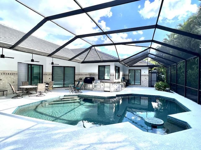 pool featuring a lanai, ceiling fan, exterior kitchen, and a patio