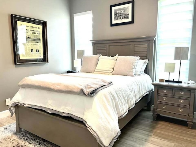 bedroom with dark wood-type flooring