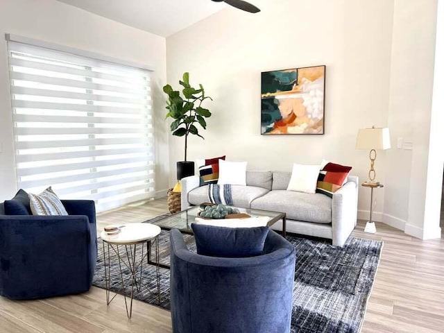 living area featuring ceiling fan, wood finished floors, and baseboards